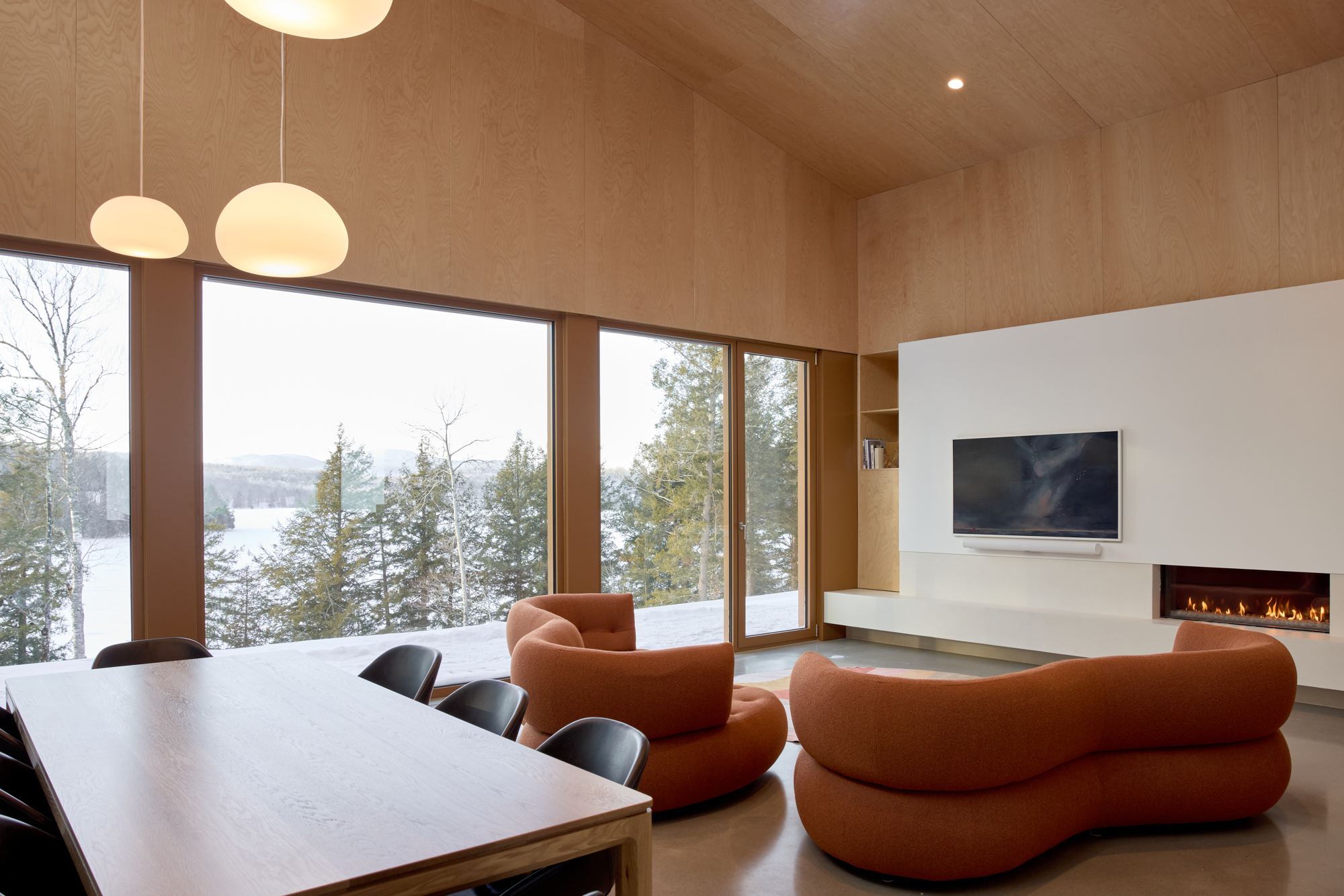 Bright living room with fireplace, coffered ceiling and soft late-day lighting