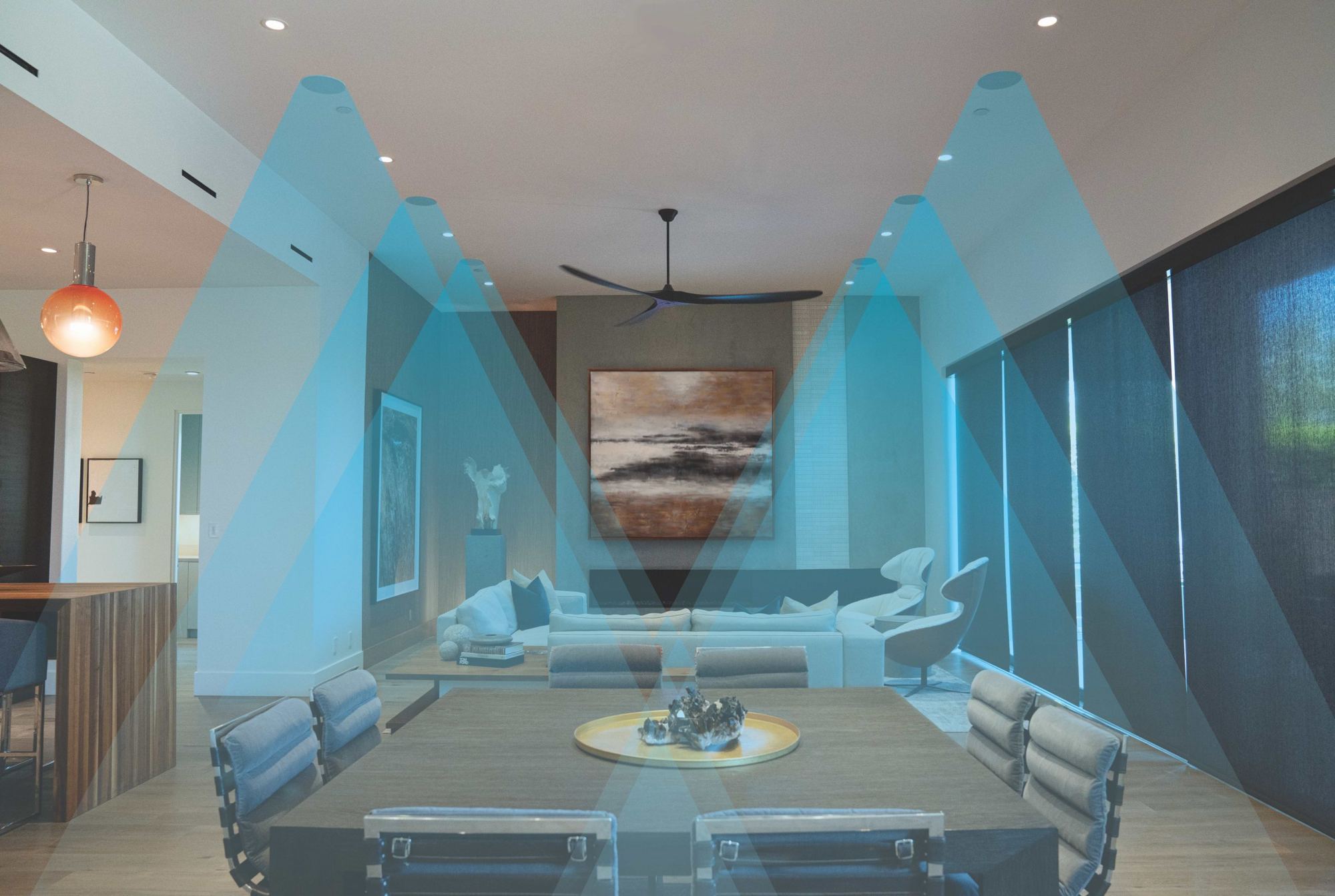 Living and dining room where blue cones show the sound from in-ceiling speakers